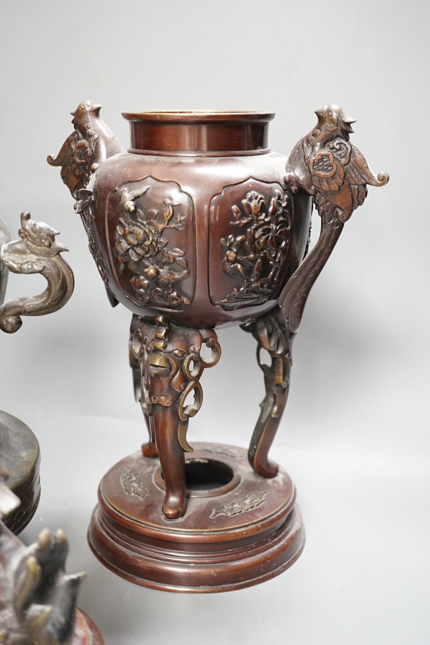 A pair of Japanese bronze vases and covers, 41 cm high and a Japanese two handled vase, 26 cm high, all Meiji period